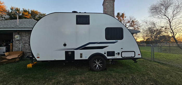 ready for your next outdoor adventure or camping trip.|Front view of an RV rental travel trailer with its propane tank and hitch