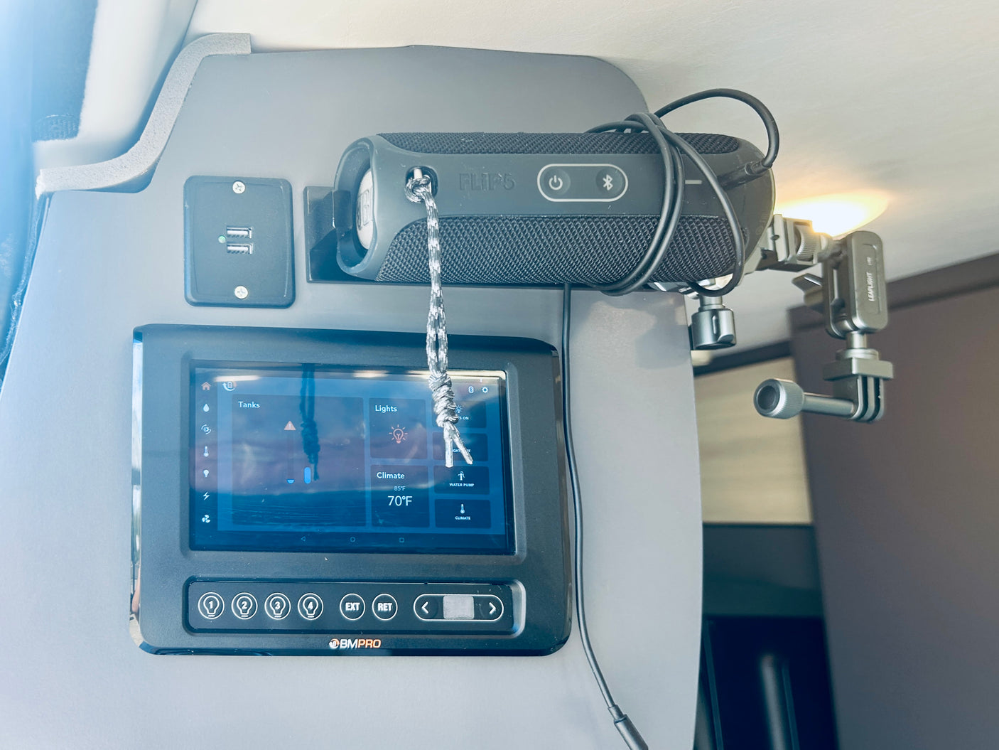 RV rental control panel showing tanks, lights, and climate (70°F), with a JBL speaker, USB ports, and a light.