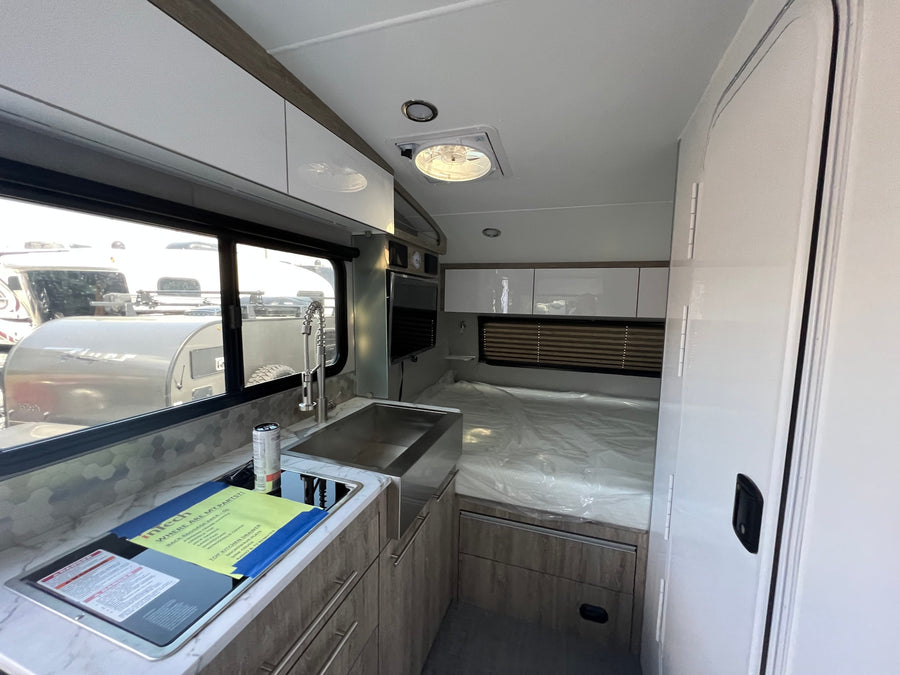 and screen.|Modern RV rental interior with a spacious U-shaped dinette