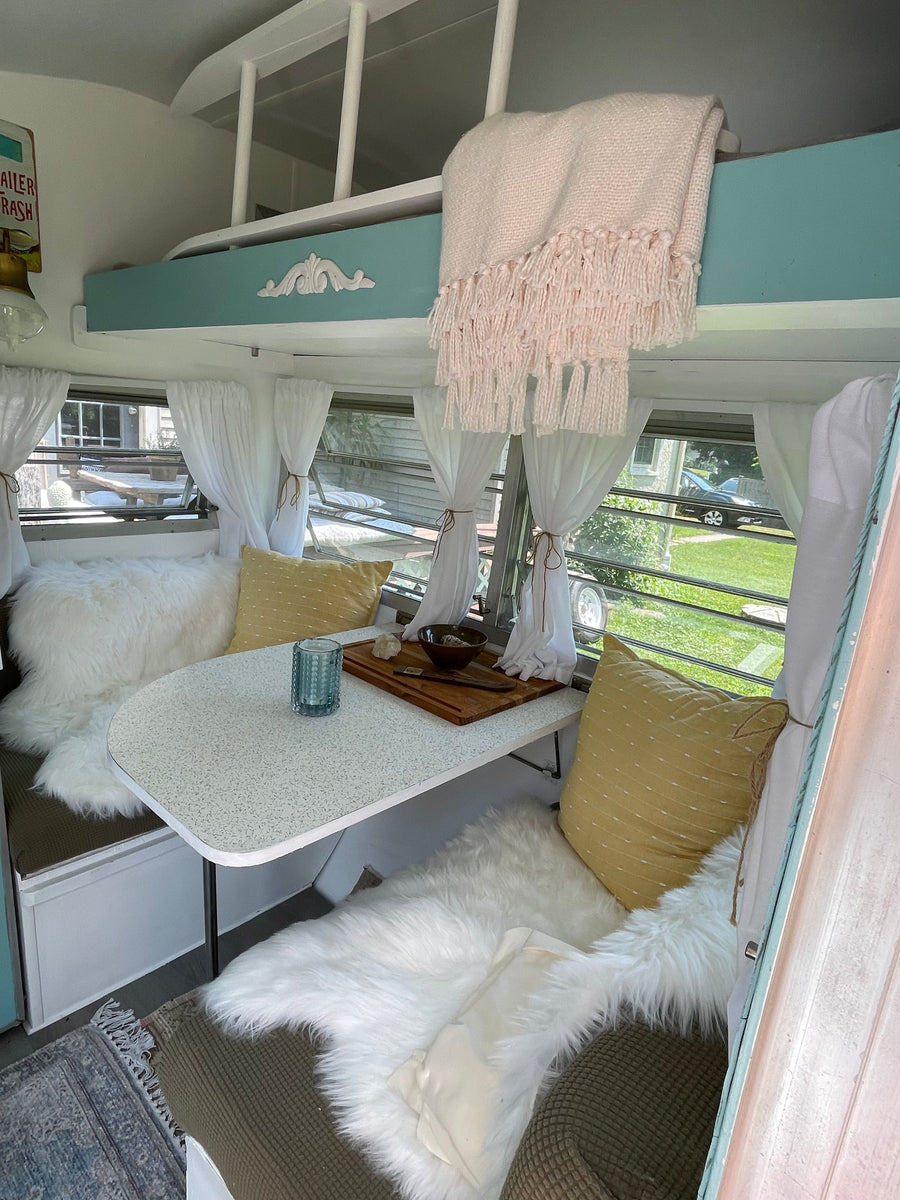 with a house in the background. Great for an RV rental!|Charming RV rental interior with a cozy dining nook
