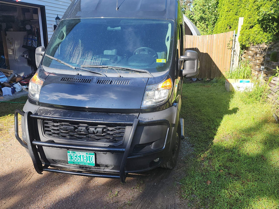 parked on gravel next to grass. Ready for your next rv rental adventure!|Black RV rental van parked by a serene marsh