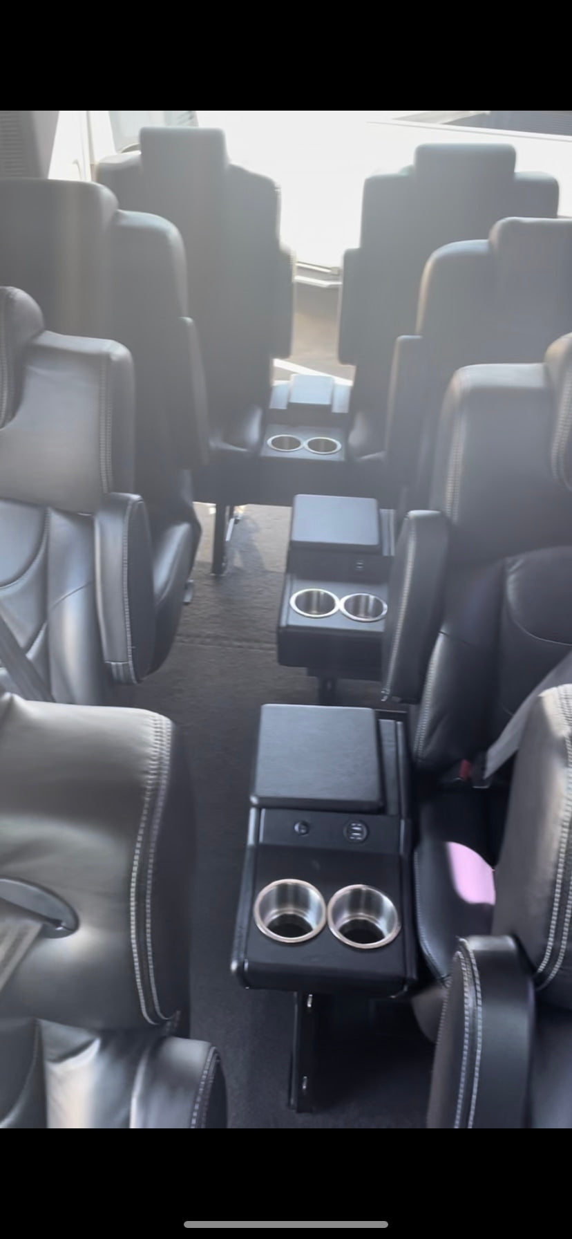 Experience comfortable group travel! Spacious black leather seating and cup holders inside this luxury RV rental.