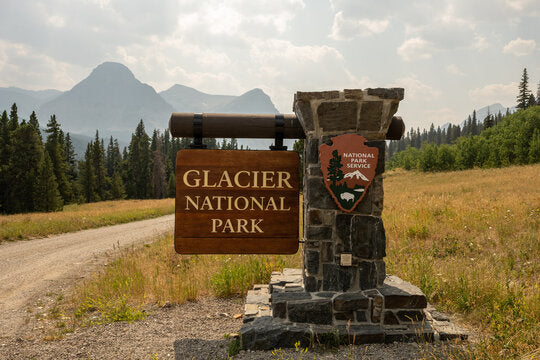 Glacier National Park entrance sign, a scenic start for your RV rental adventure through mountains and nature.