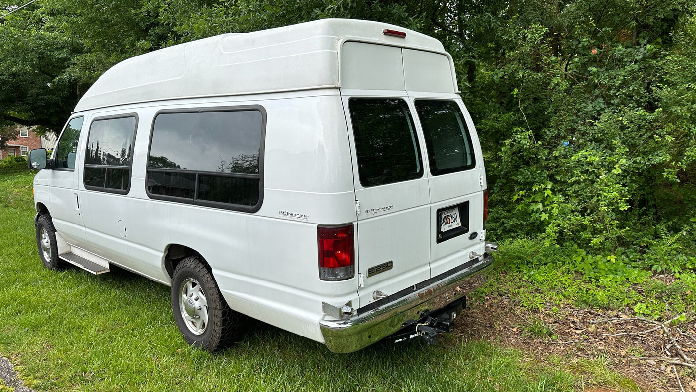 ready for travel.|White high-top Ford E-Series conversion van (Transmaster)
