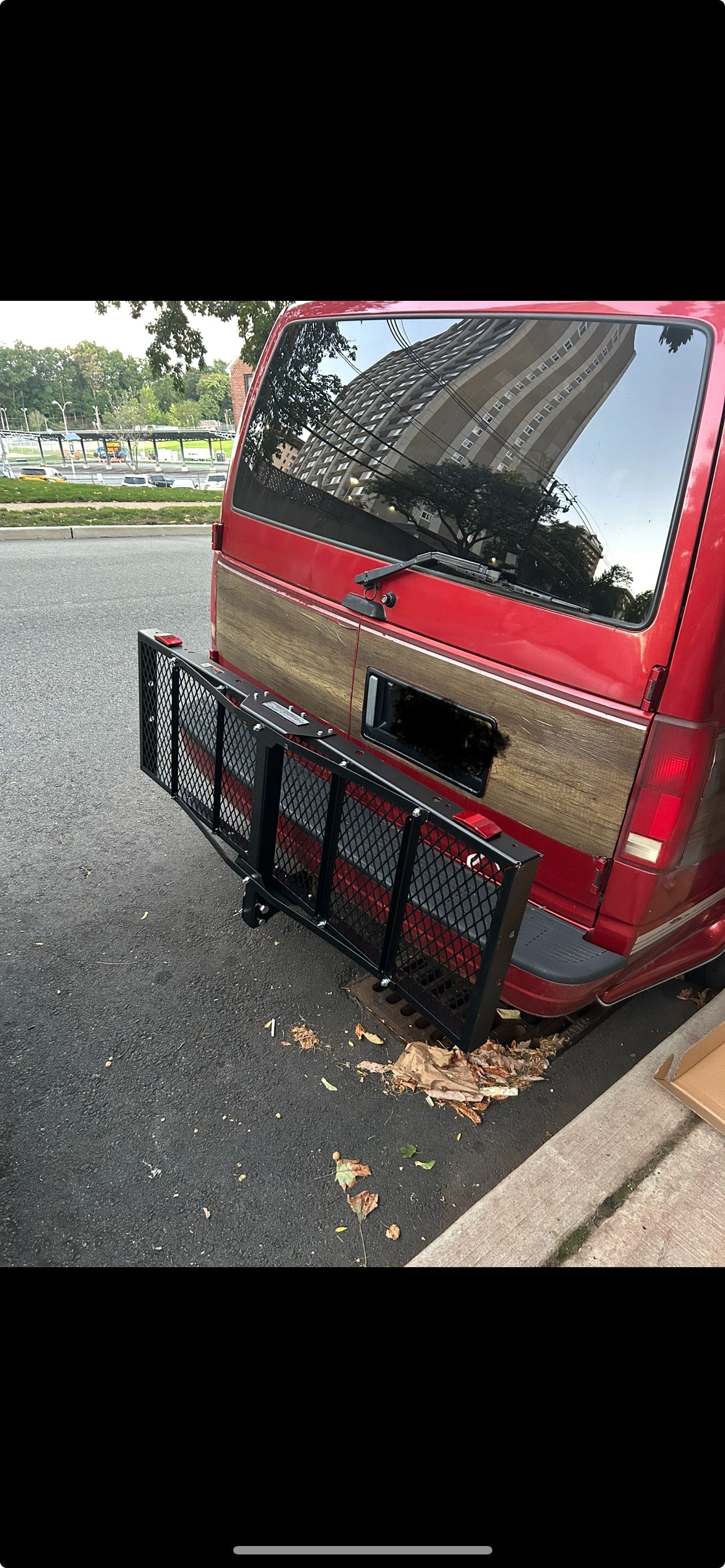 parked by a stone wall and bridge; could be an RV rental.|RV rental: Interior of a camper van with a spacious gray quilted bed