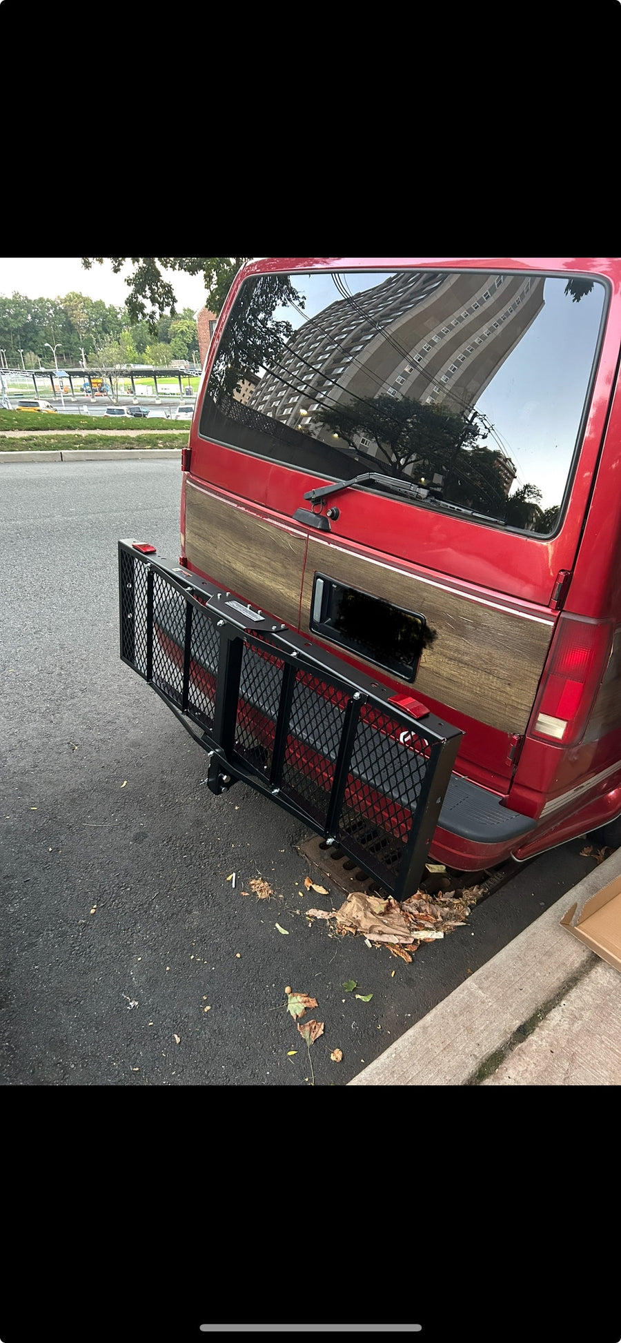 parked by a stone wall and bridge; could be an RV rental.|RV rental: Interior of a camper van with a spacious gray quilted bed