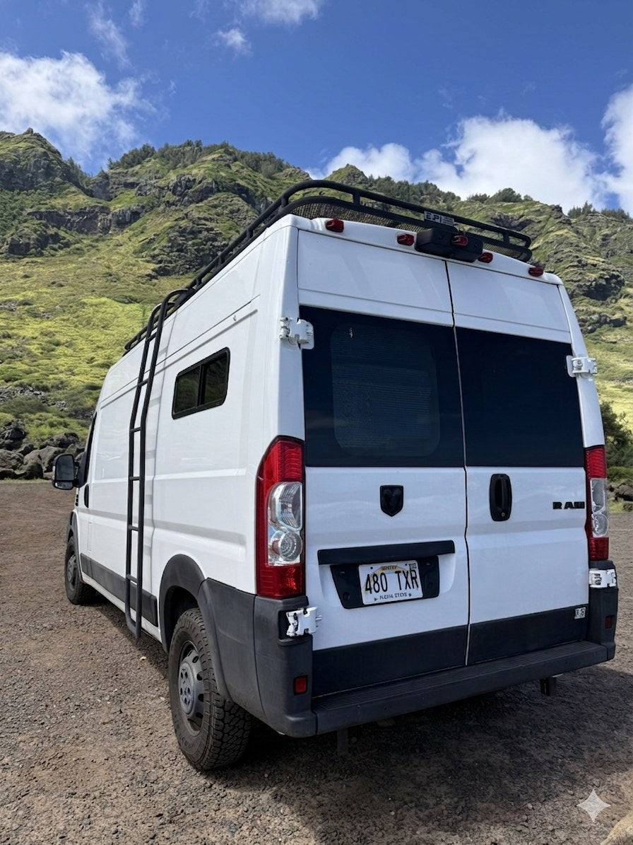 parked oceanfront under a bright blue sky for van life adventures.|Coastal RV rental: A white Ram camper van with a roof rack — photo 2