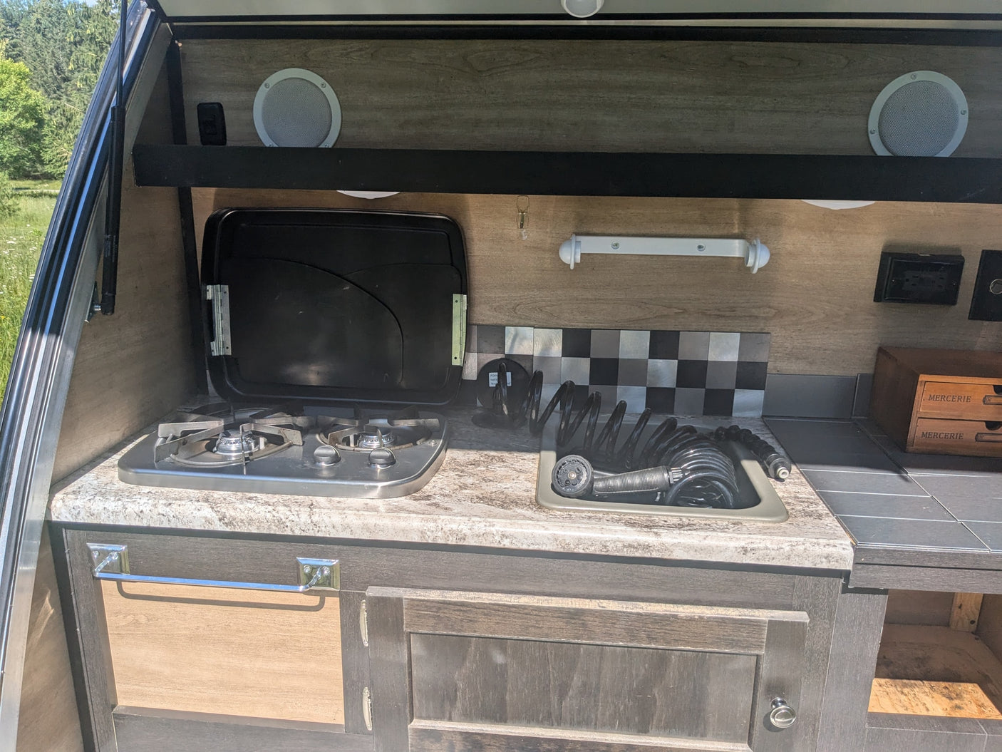 on a grassy field.|Bushwhacker teardrop camper