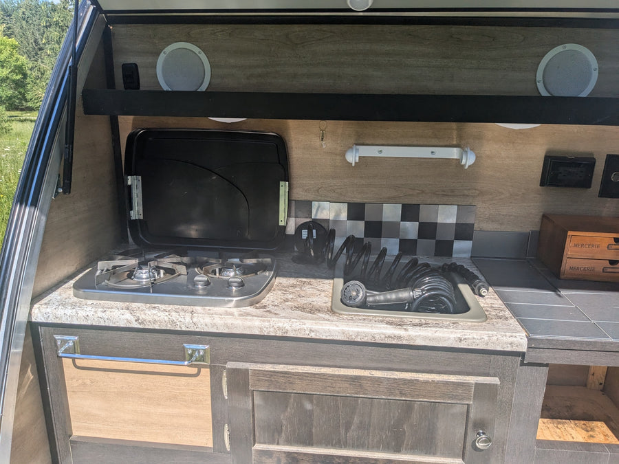 on a grassy field.|Bushwhacker teardrop camper