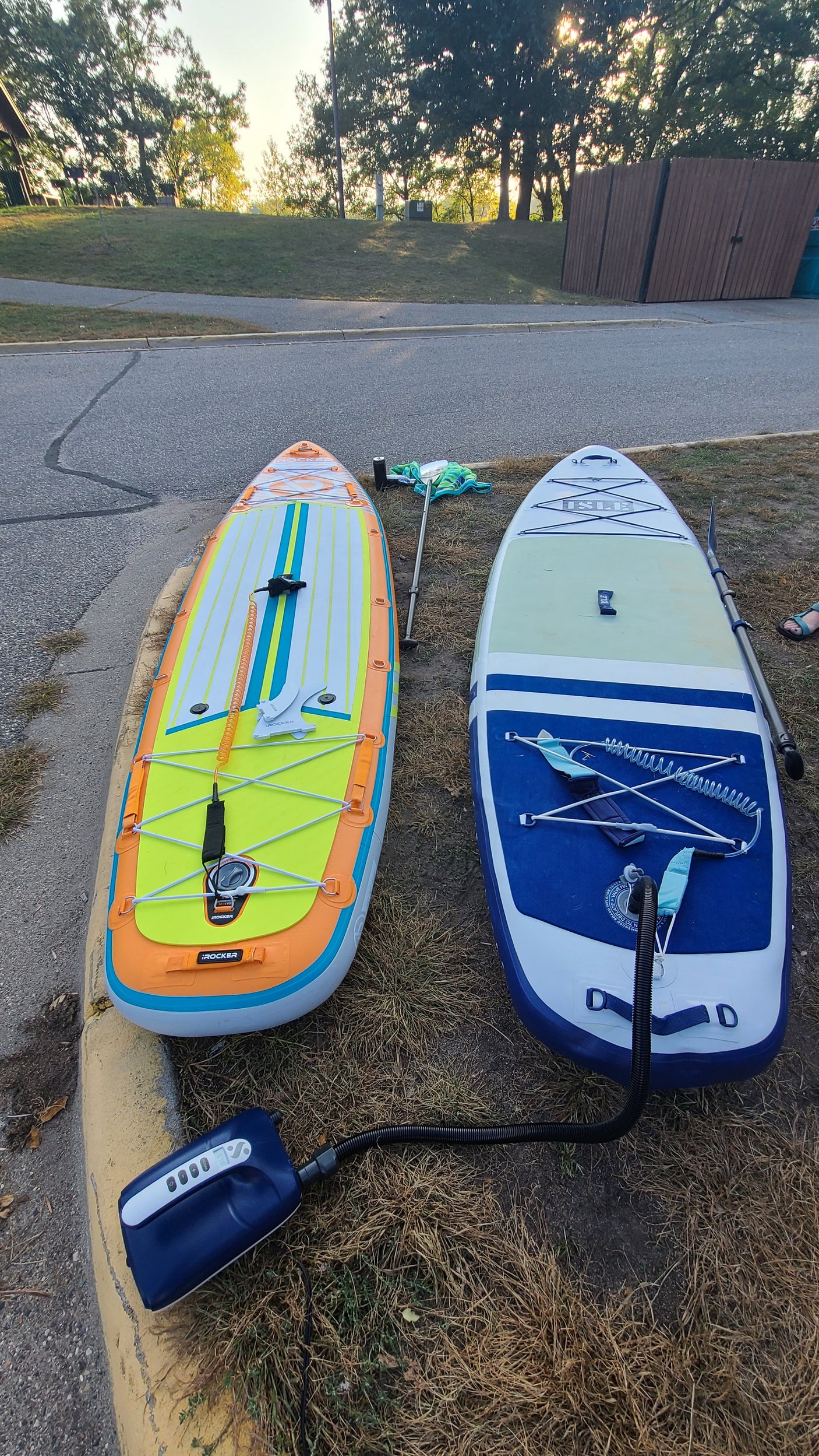 Two vibrant inflatable paddleboards with an electric pump, ready for an RV rental adventure!