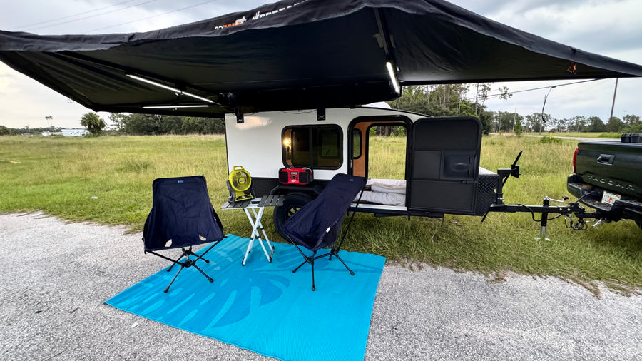 An inviting RV rental setup: a small camper with extended awning