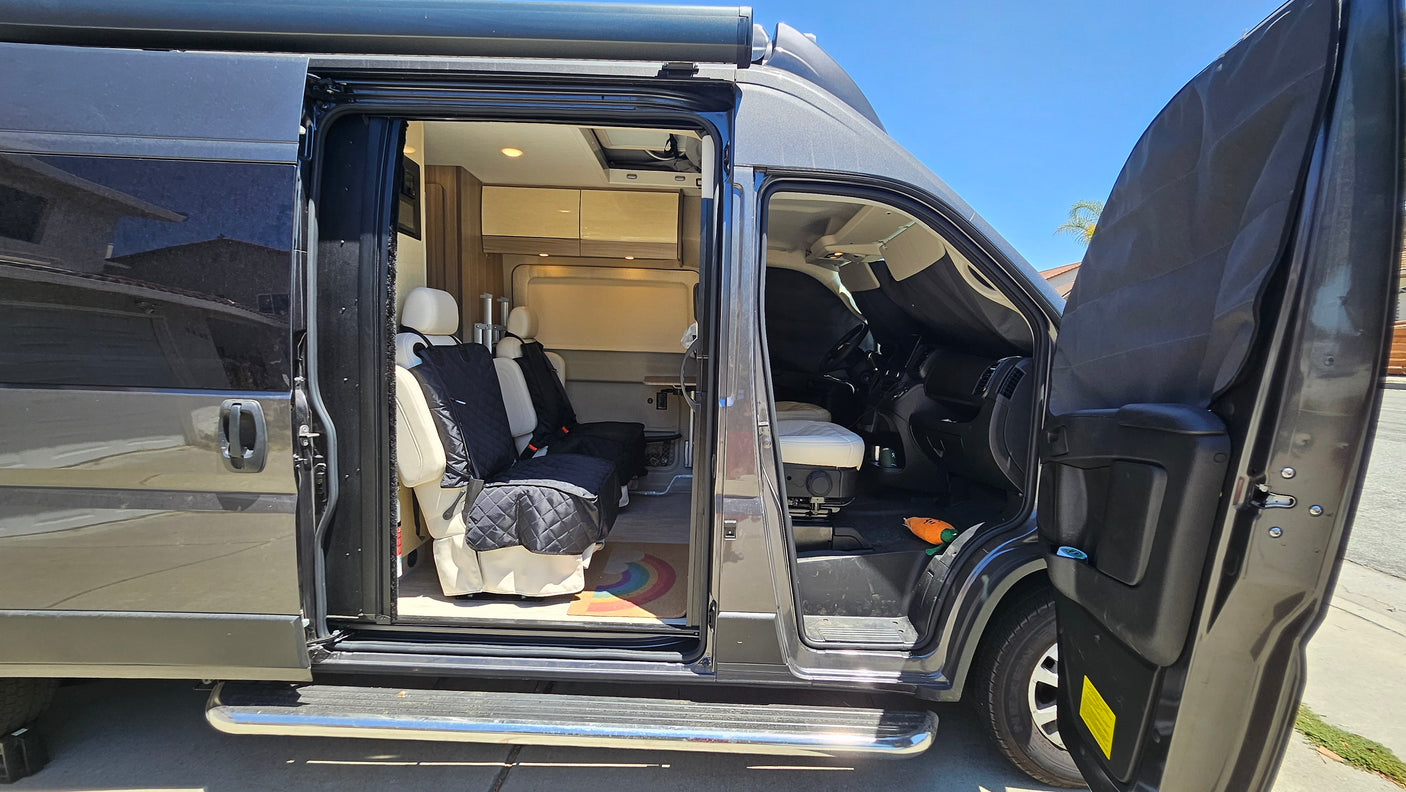 Spacious RV rental with open doors showcasing its modern interior, perfect for your next road trip adventure.