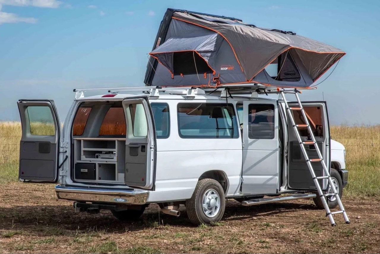 parked in a scenic field with mountains. Ideal for adventure travel.|Explore van life with this RV rental: a white camper van with an open rooftop tent — photo 3