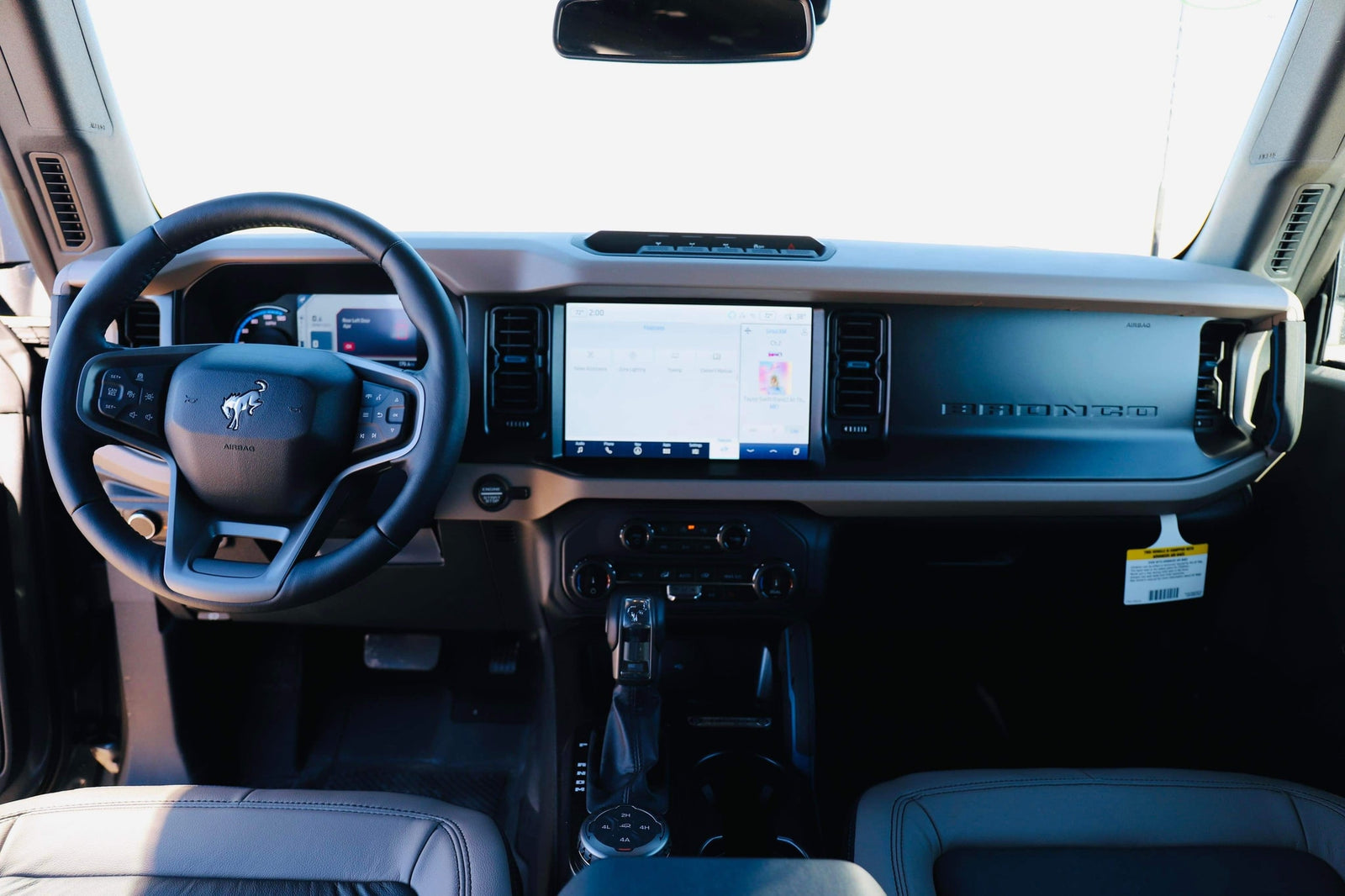 Detailed interior of a modern Ford Bronco, its dashboard and controls visible. A versatile option for your next rv rental adventure.