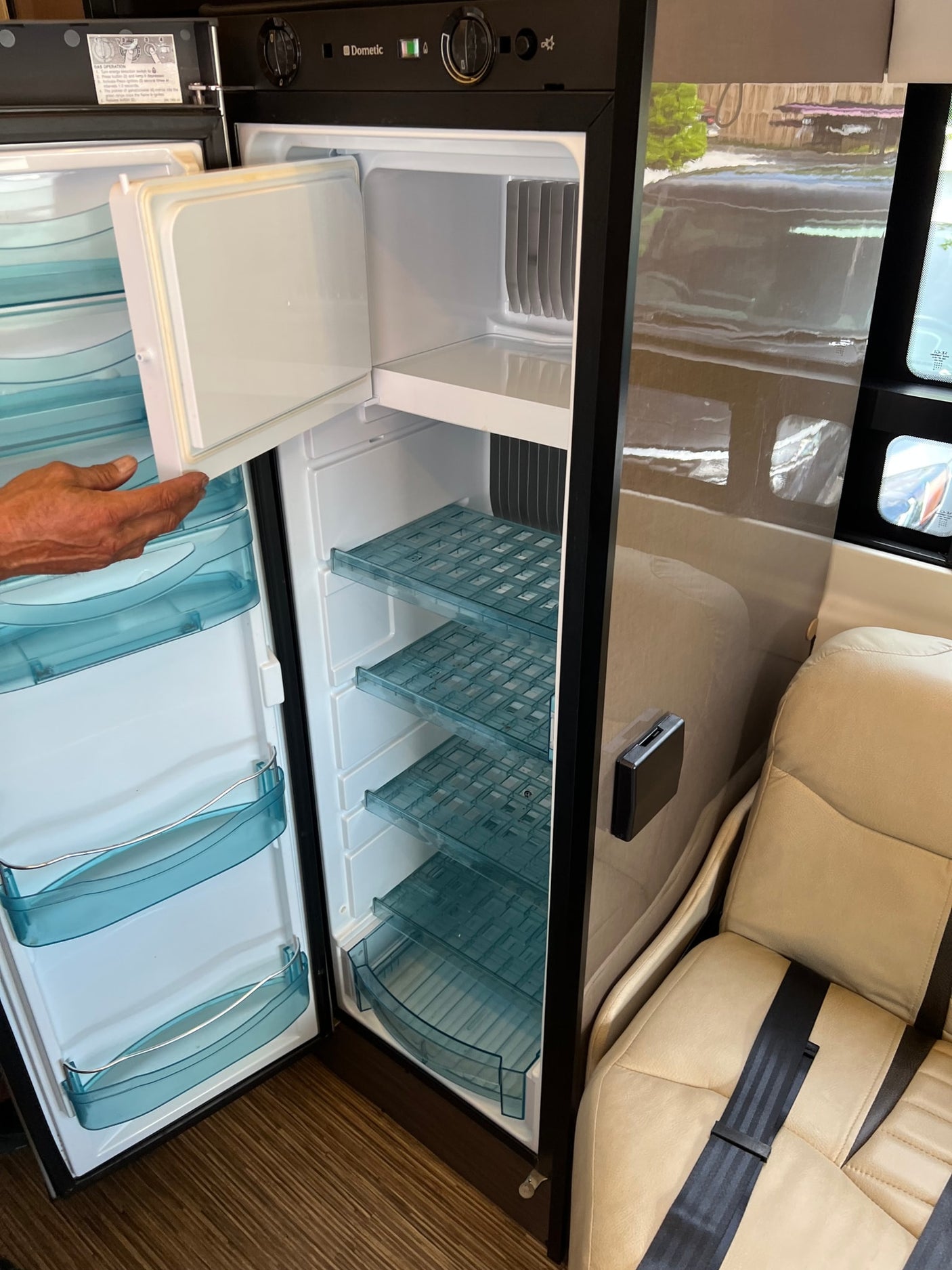 showing its tow hitch.|Interior of an RV rental: a plush