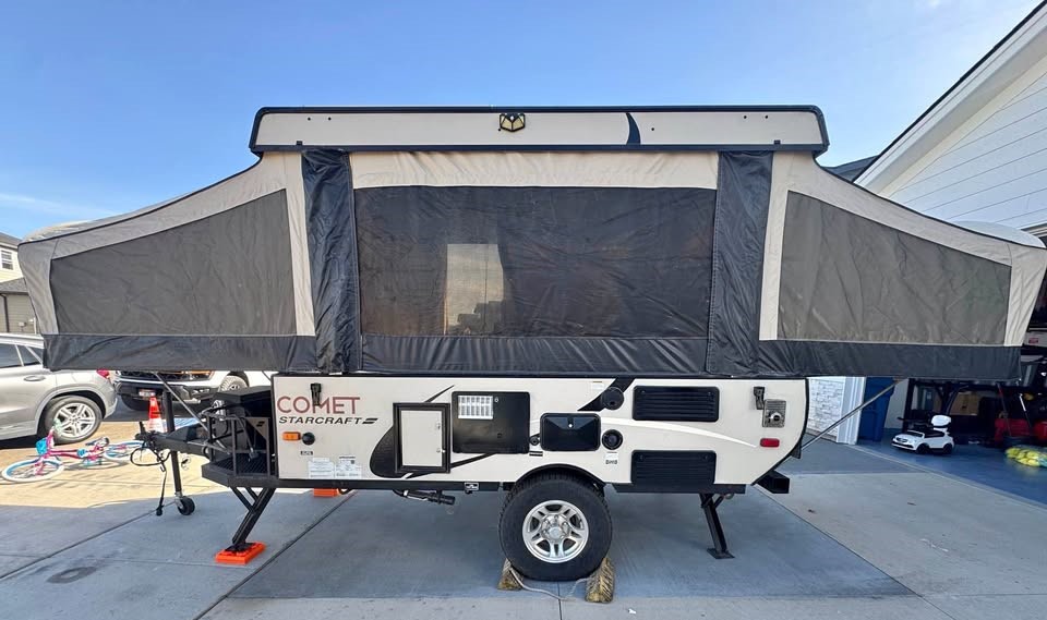 an ideal RV rental. This beige & black folding trailer is expanded