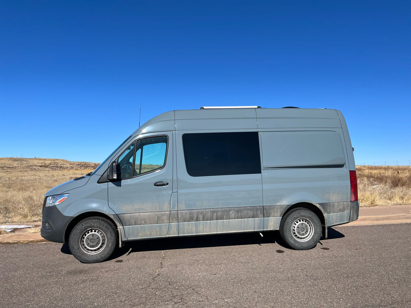 fire pit & bikes. Mountain scenery.|Sprinter rv rental parked riverside by tall pines & cliffs. Ideal for an outdoor adventure.|Gray RV rental Sprinter van at scenic campsite 5 — photo 5