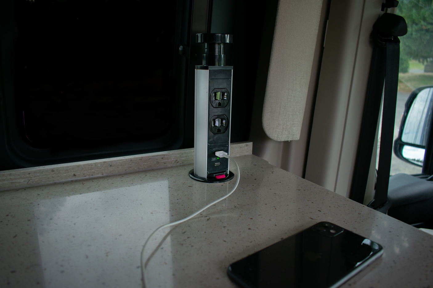 Stay powered up in your RV rental! This modern interior features a pop-up power outlet with USB ports for convenient device charging.