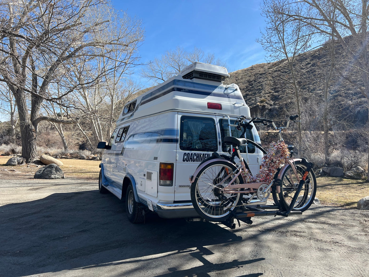 parked outdoors.|Explore in this white Ford Econoline Coachmen camper van — photo 3