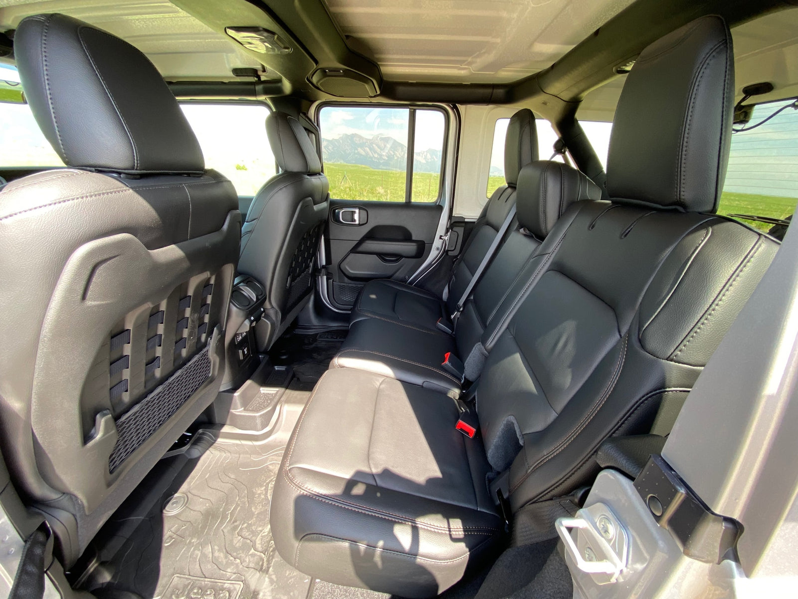 Roomy back seats of a Jeep SUV, ready for rugged adventures. A flexible choice for your RV rental needs.