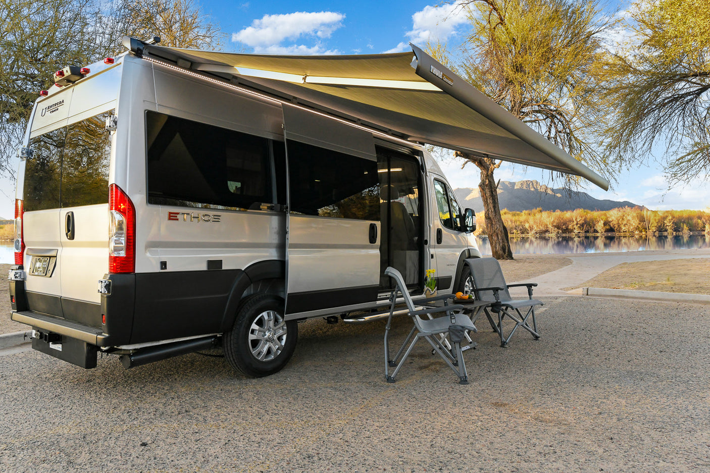 Lakeside ETHOS camper van rv rental with extended awning and outdoor seating, perfect for serene travel and leisure.