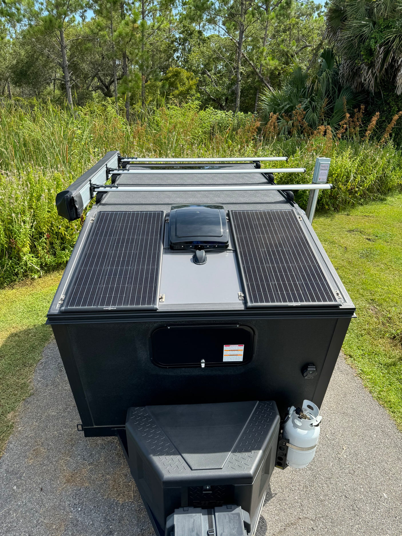 Top-down view of an RV rental trailer with solar panels, ready for off-grid camping and nature adventure.