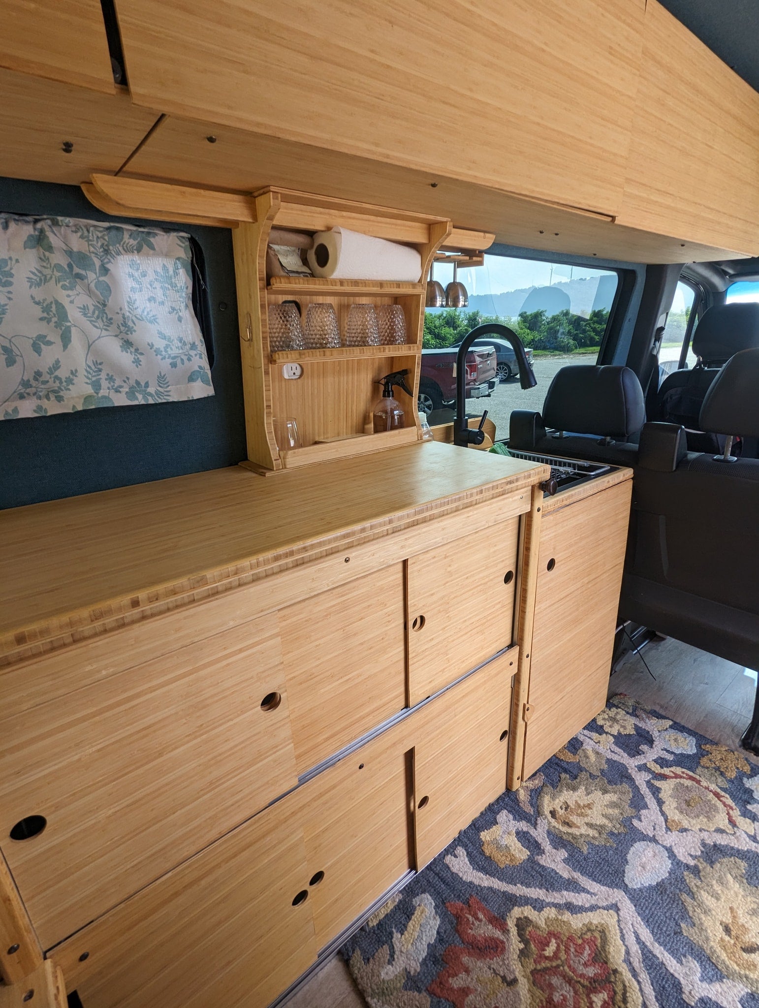 and overhead storage for comfortable travels.|Spacious and well-appointed RV rental interior with bamboo cabinetry