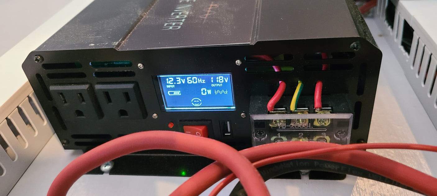 An RV rental power inverter converts 12.3V battery power to 118V AC output, showing 0W usage.