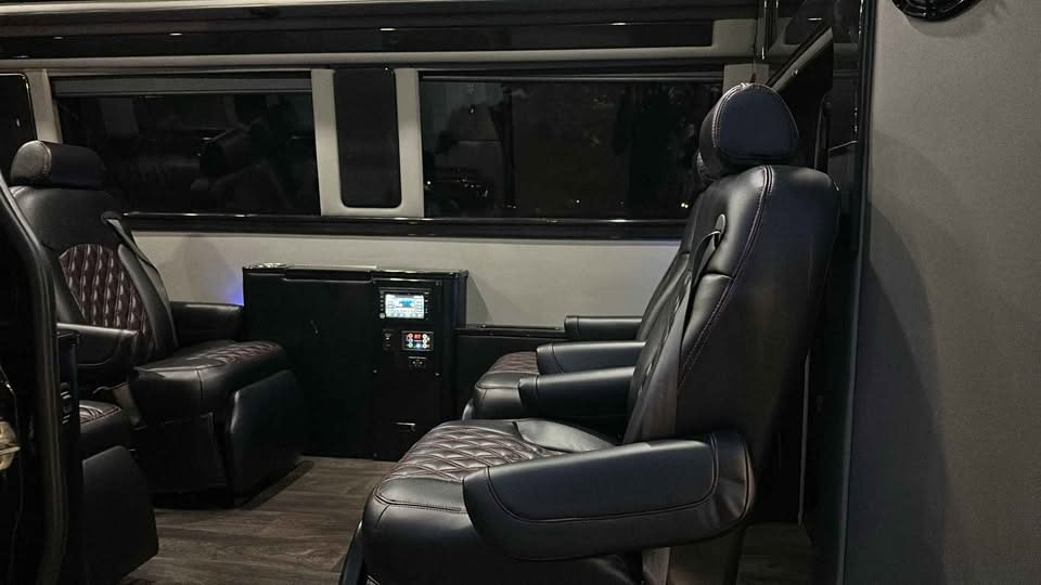 and ambient lighting for comfort.|Step into luxury with this RV rental: black leather captain's chairs