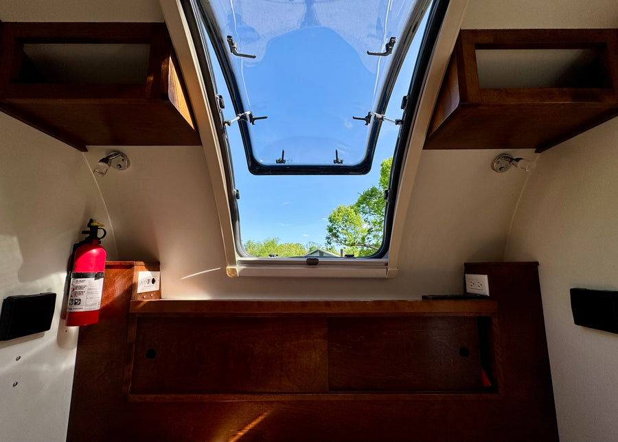 ready for adventure.|A white and blue T@G teardrop RV rental