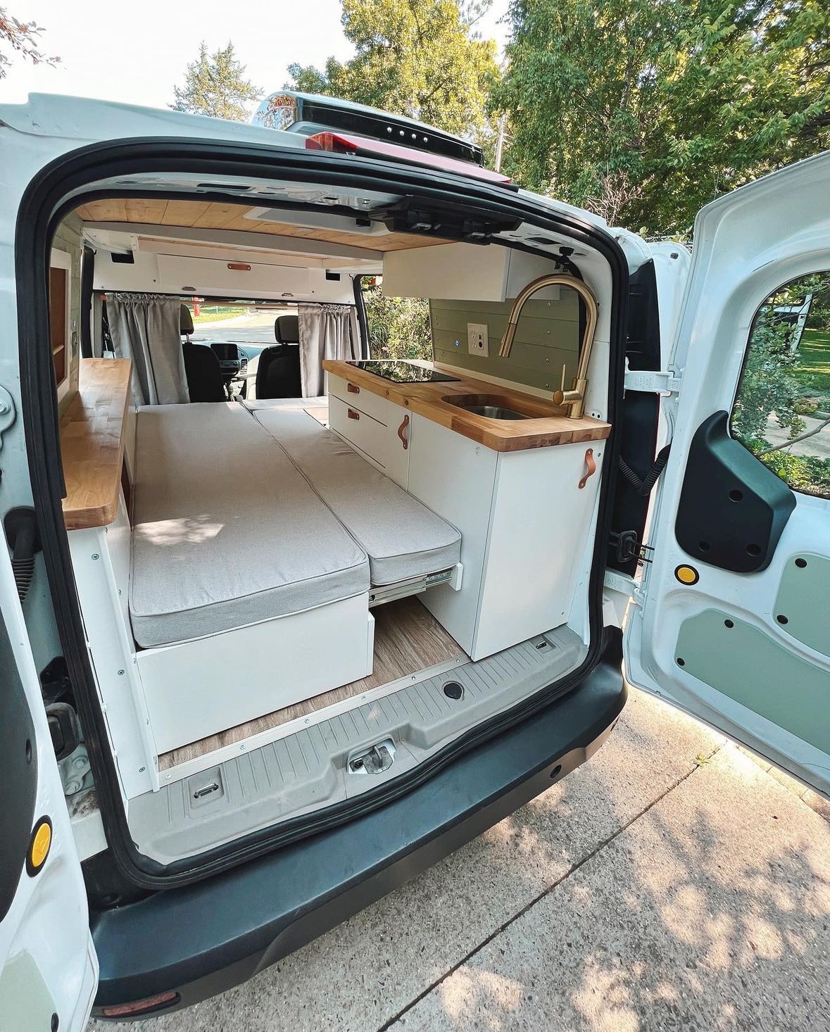 and cozy bench seating.|RV rental: Compact camper van conversion. Features a modular bed — photo 3