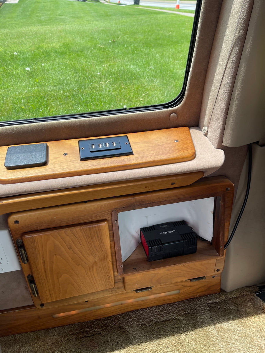 and disc slots for in-vehicle viewing.|RV rental: Built-in wall compartment holding a portable vacuum cleaner with tangled cords