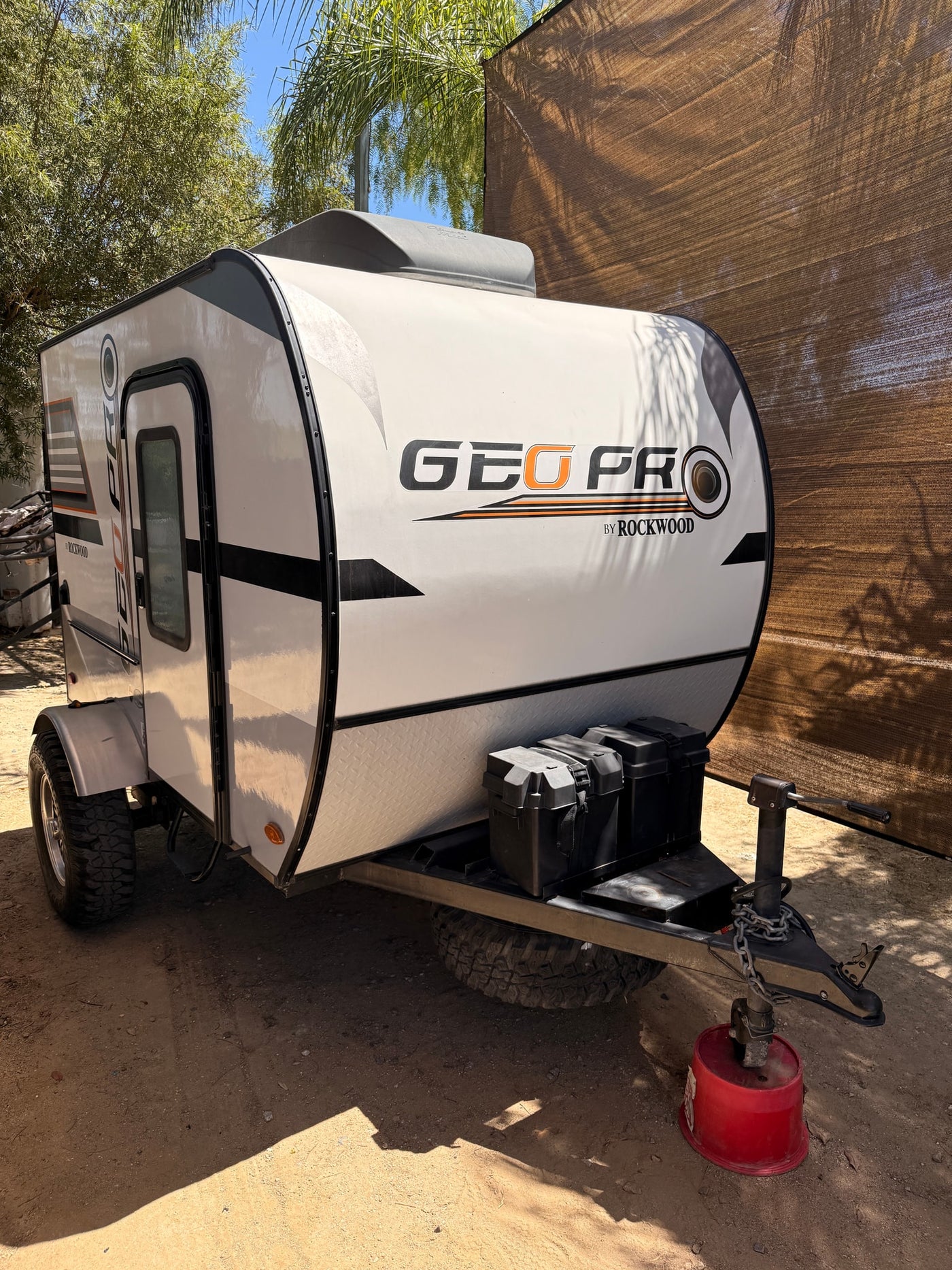A Geo Pro by Rockwood compact RV rental, an off-road ready travel trailer, parked outside on a sunny day. — photo 1