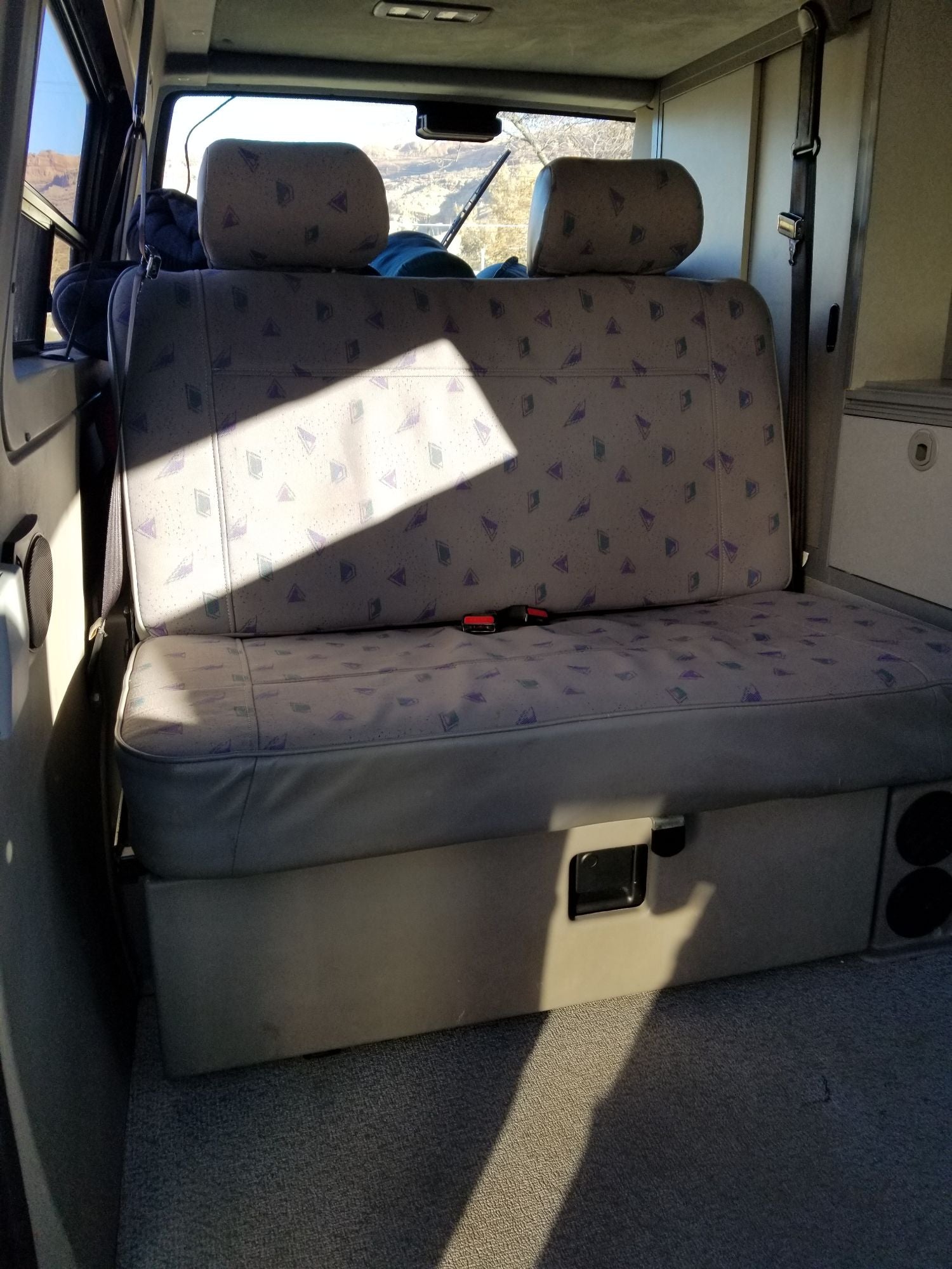and open tailgate.|White pop-top camper van