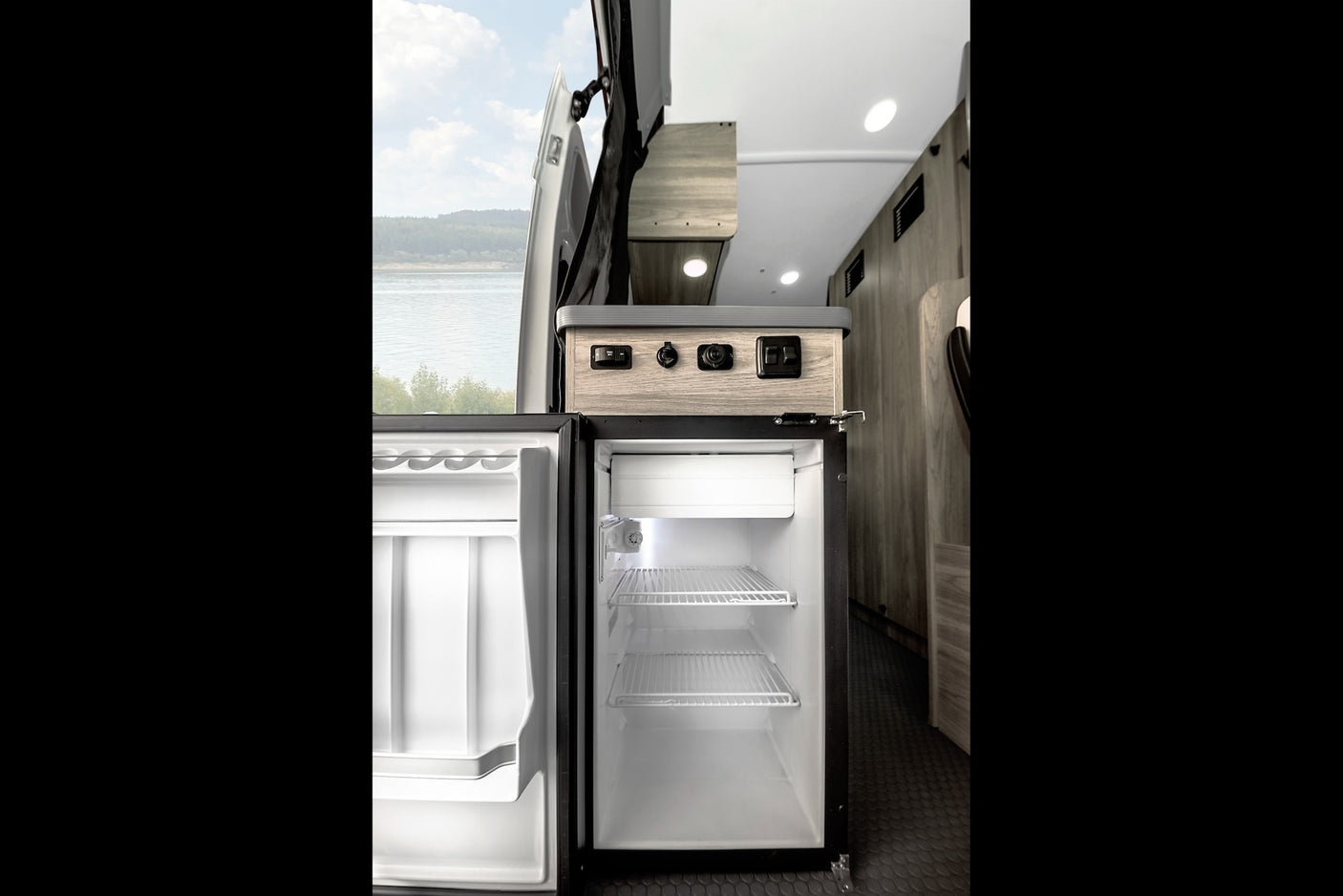 and scenic mountain views.|Cozy RV rental pop-top sleeping area with a patchwork bed