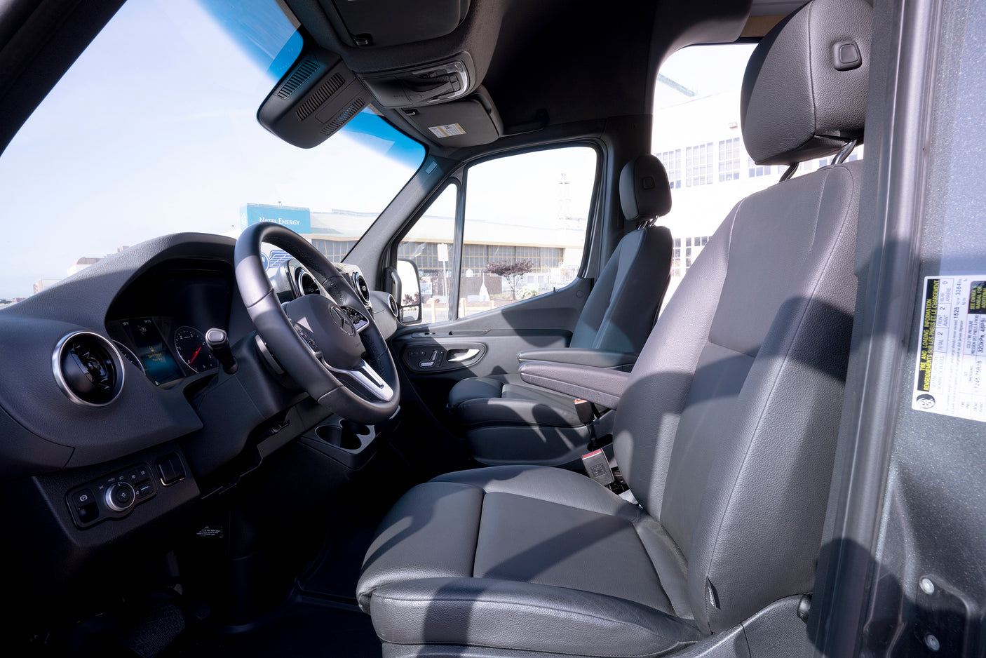 Inside a spacious van, ideal for rv rental: detailed view of the modern driver's cabin, dashboard, and front seats.