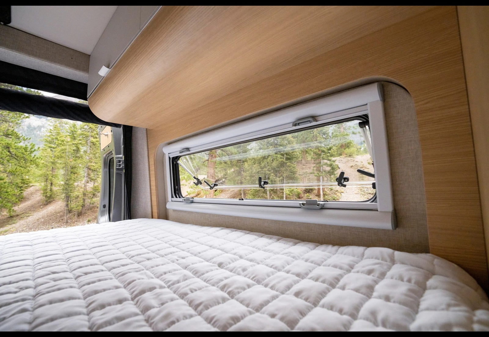 and seating.|RV rental kitchen with a sleek stainless steel faucet