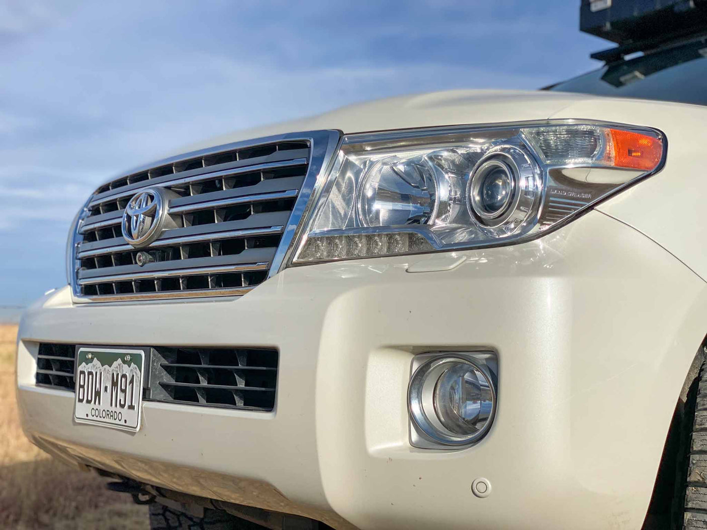 ready for off-road adventure.|White Titus Adventure Co. overland SUV (like an RV rental) with awning