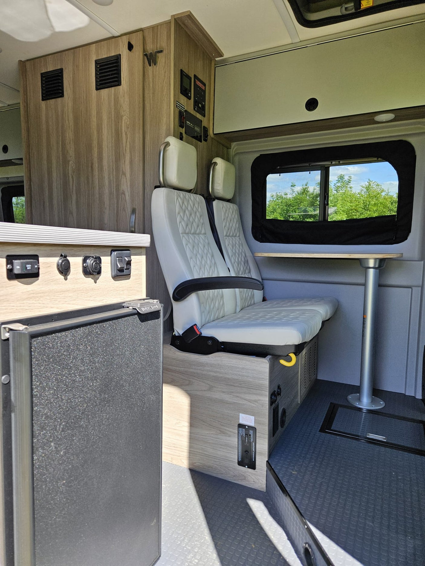 and view of nature outside. Ready for adventure!|Explore this bright RV rental interior with a functional kitchen
