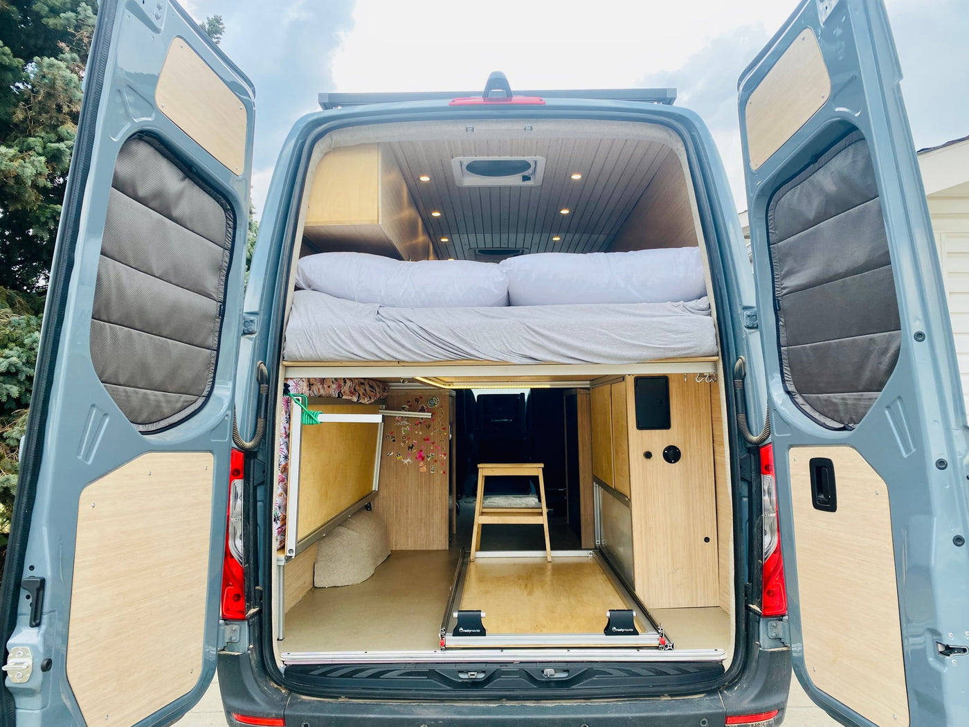 and kitchen counter.|This rv rental camper van's interior showcases swiveling front seats — photo 7