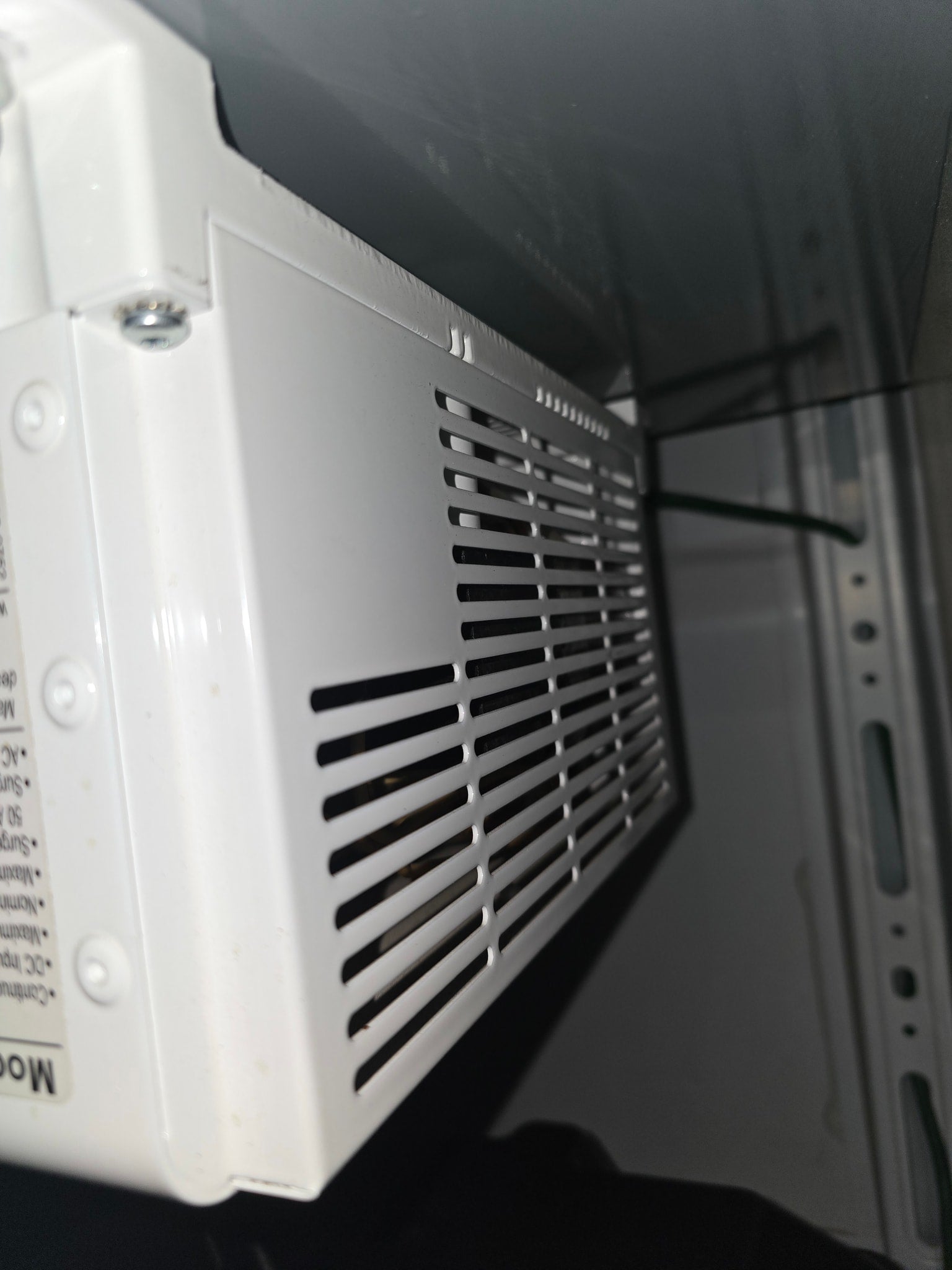 possibly for rv rental. Chrome shelving unit holds supplies; black textured floor.|Robust rv rental power system: dual Deka batteries
