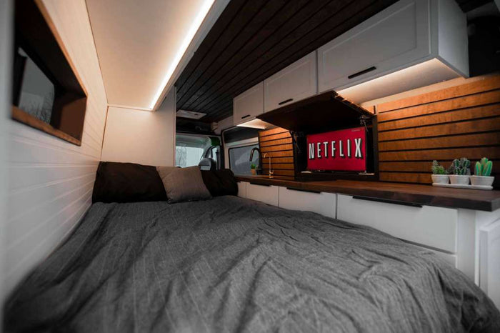 custom RV rental interior featuring a kitchen with wood counters