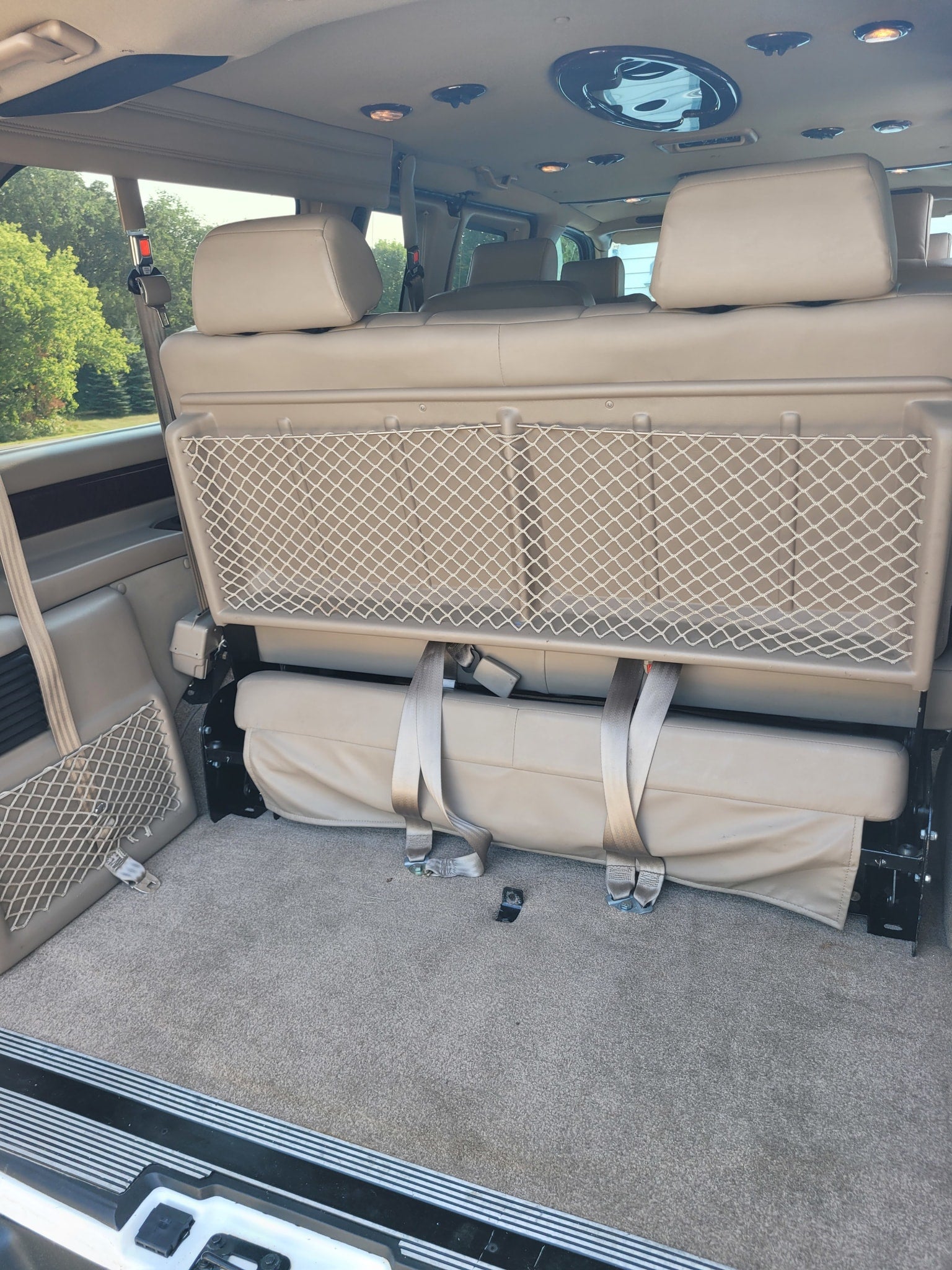 and two consoles with cupholders and a power outlet.|RV rental convenience: Center console with built-in cooler