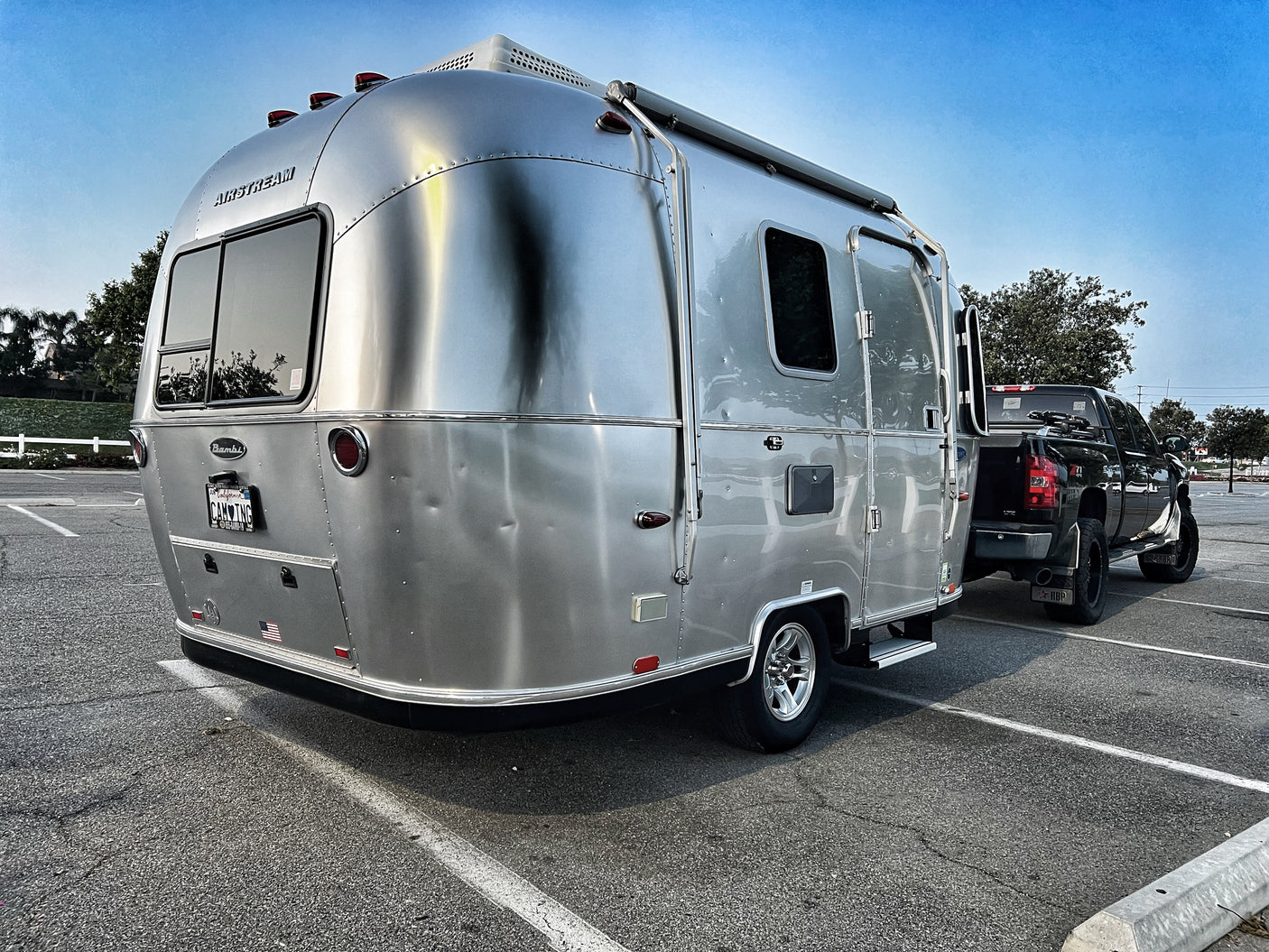 This iconic silver Airstream Bambi travel trailer and truck, parked and ready for your next RV rental camping trip.