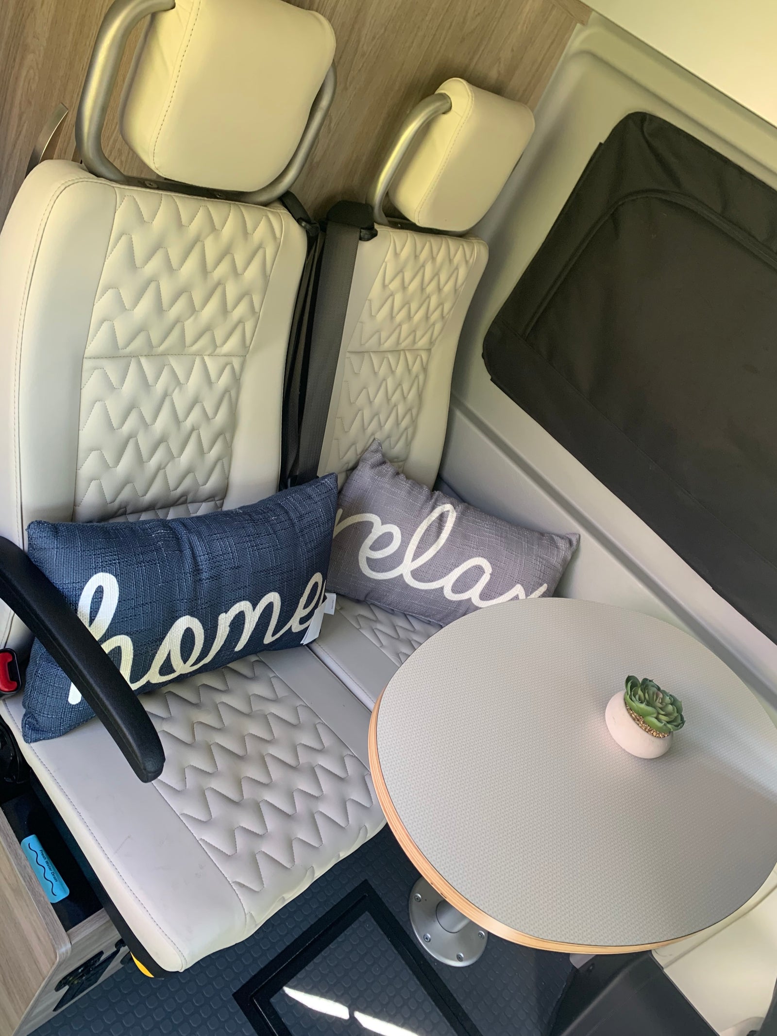 parked at a peaceful campground with a child enjoying outdoor play.|A well-stocked drawer in an RV rental with a first aid kit