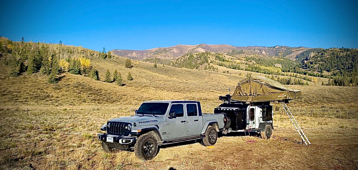 Experience off-grid adventure! This Jeep Gladiator & overlanding trailer with rooftop tent offer the perfect RV rental for mountain camping.