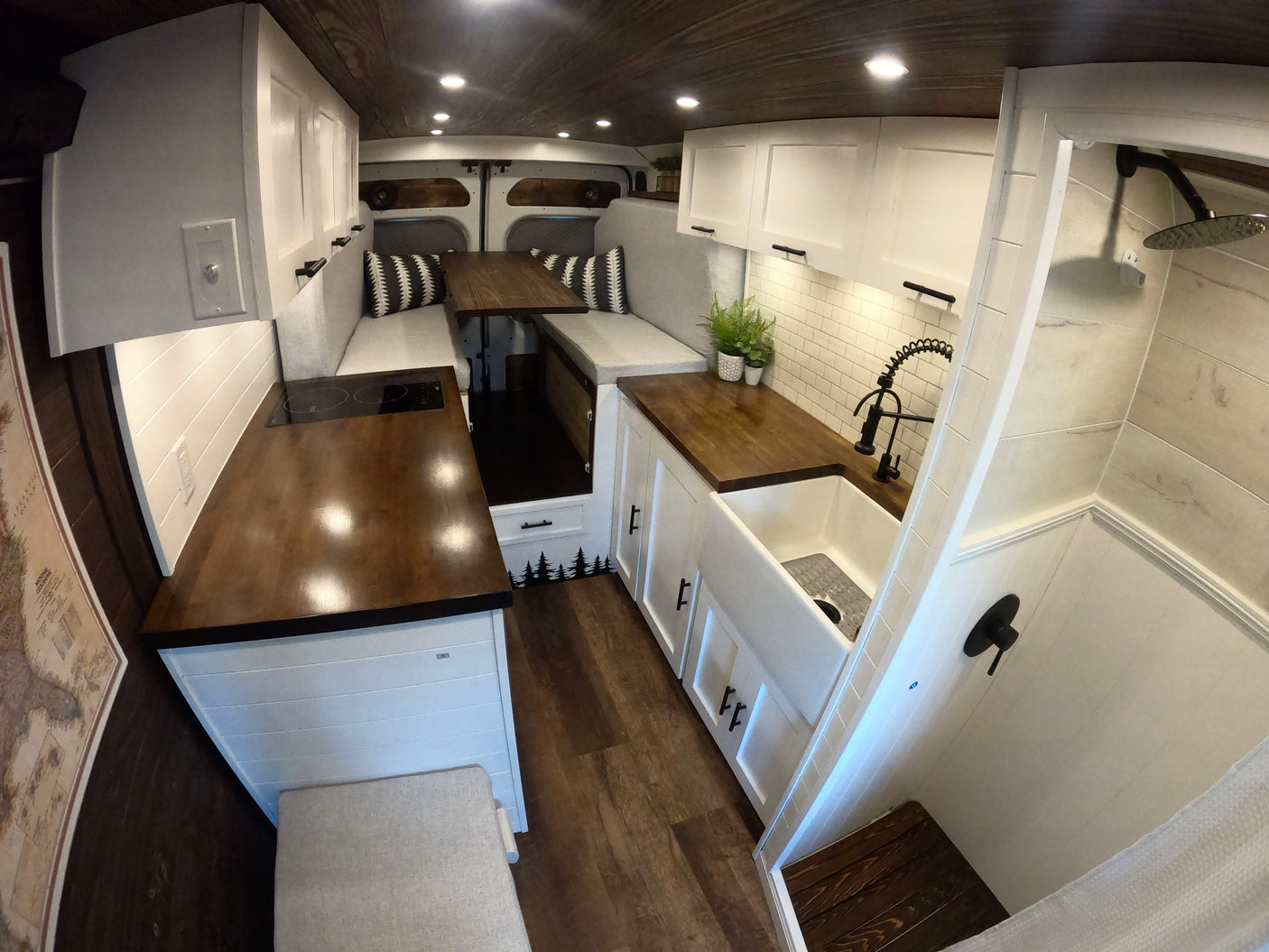 Explore this clean, modern RV rental. It features a full kitchen, convertible dining/sleep area, and a functional shower.