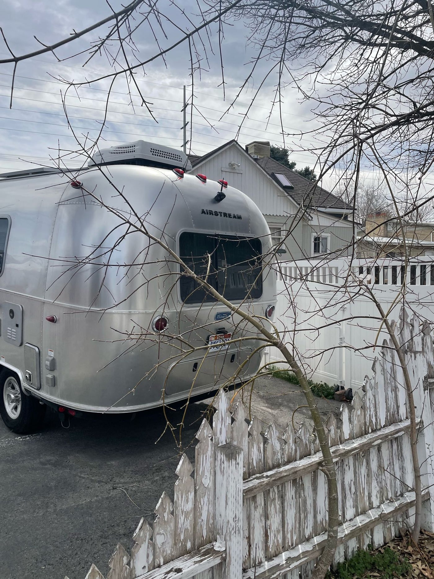perfect for any weather. Rain visible outside.|This RV rental kitchenette shows a compact cooking area with a sink — photo 10