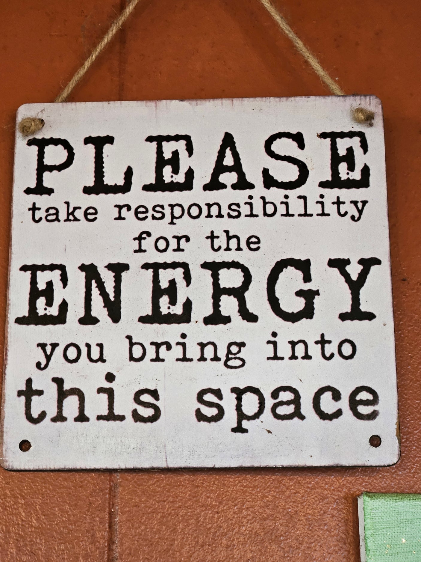 White sign with text 'PLEASE take responsibility for the ENERGY you bring into this space', ideal for an RV rental.
