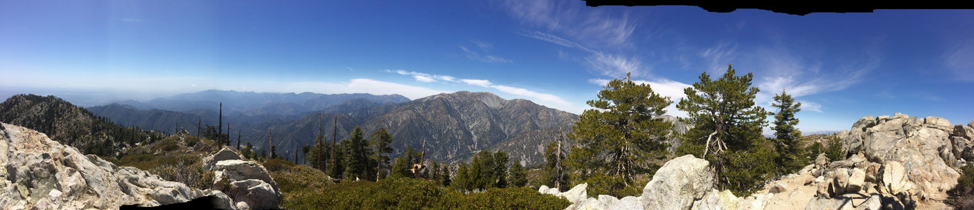 Panoramic mountain vista from a rocky peak. Enjoy this stunning natural beauty on your next RV rental adventure under clear skies.